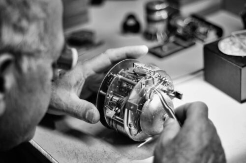 Watchmaker Examining Clock