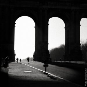 Main Subject: An architectural structure, possibly a historical bridge or overpass, with several peo