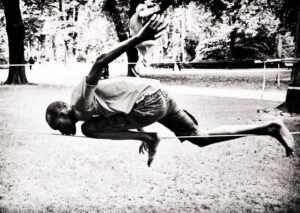 Main Subject: A black and white photograph capturing a moment of an individual engaged in an athleti