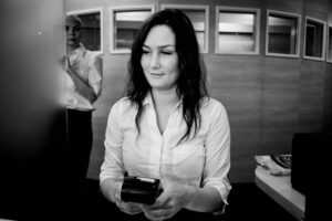 Main Subject: A woman Visual Elements: The image is a photograph with a portrait orientation, captur